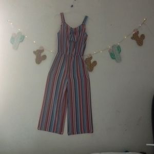 A super cute jumpsuit that is pink,two kinds of blues and white